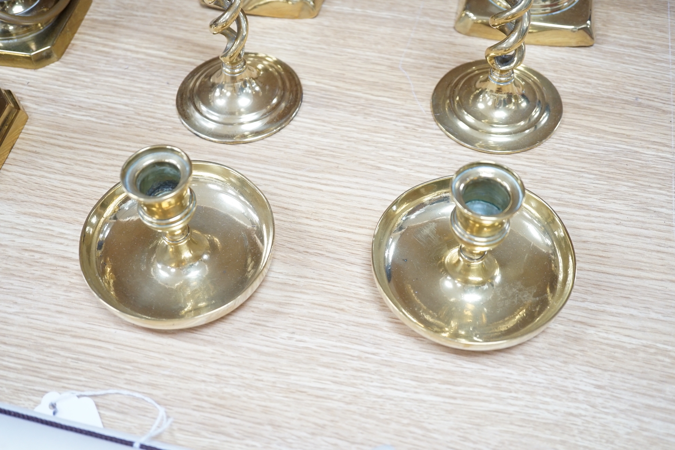 Four pairs of brass candlesticks, and another three converted to lamps, tallest 31cms high